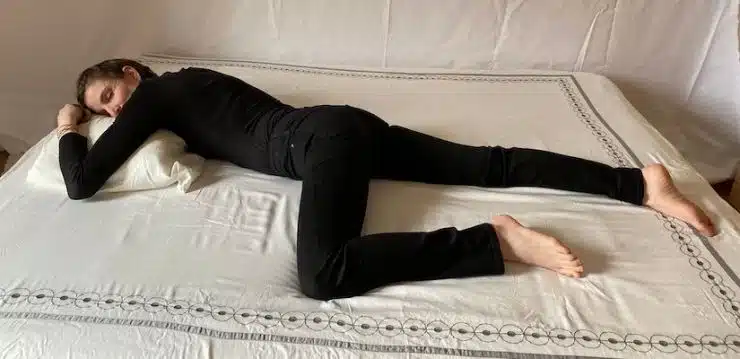 Jeune femme dormant sur le ventre, illustrant une mauvaise posture de sommeil